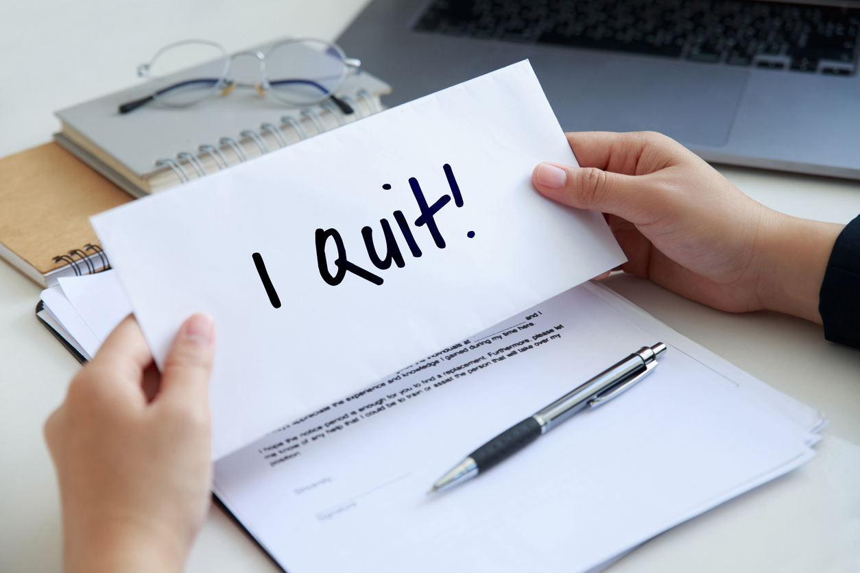 Close up woman hands holding a piece of paper of I quit the job.