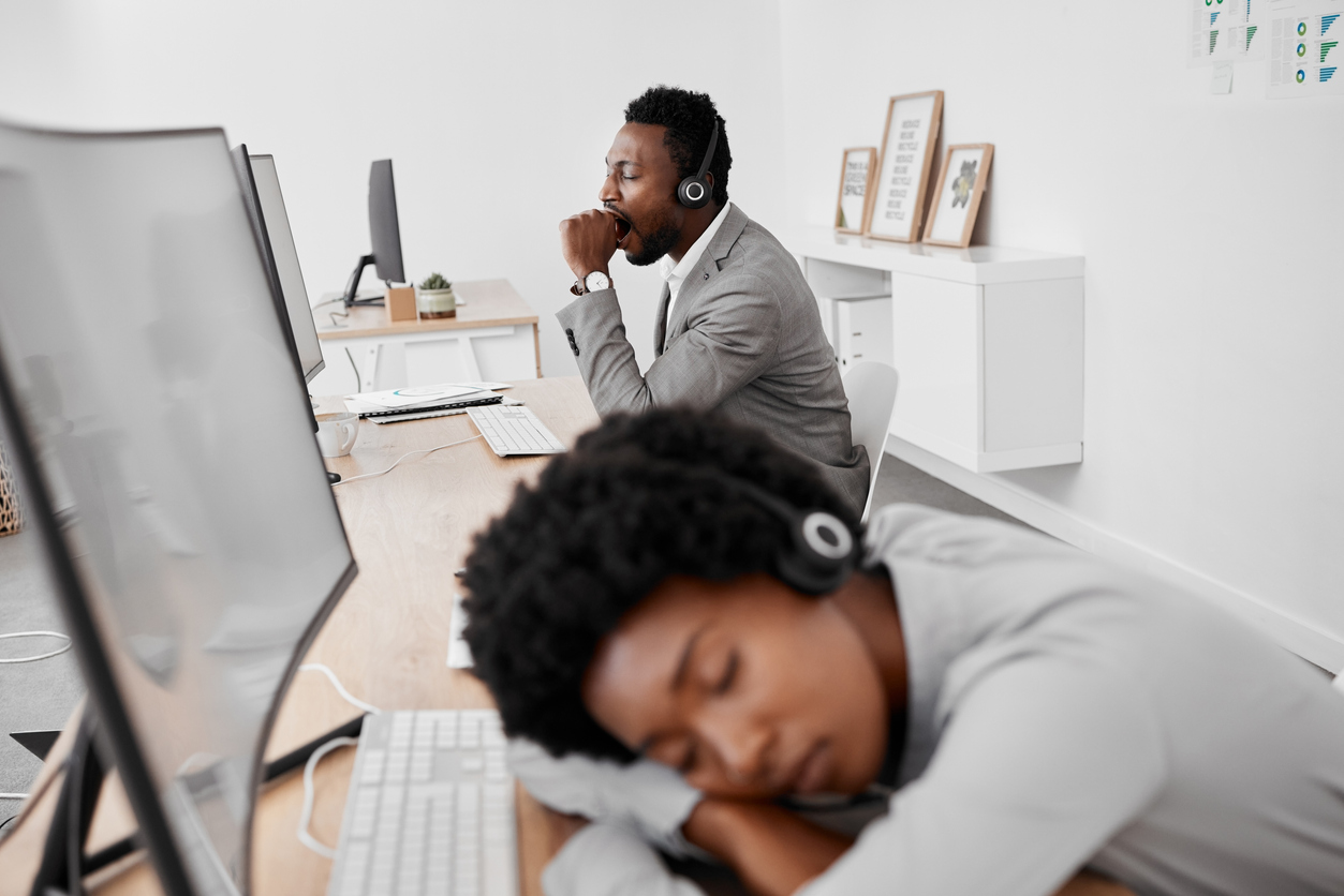 Burnout, yawn and tired call center people sleeping on desk with computer.