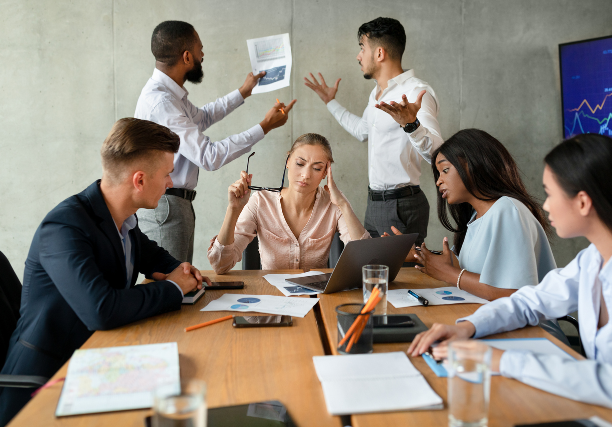 Stressed Group Of Business People Having Disagreements During Corporate Meeting.