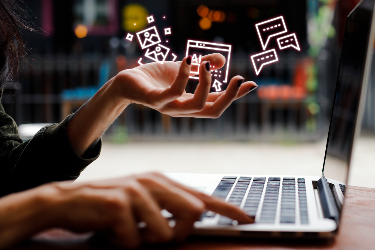 Woman holding ai icons with laptop.