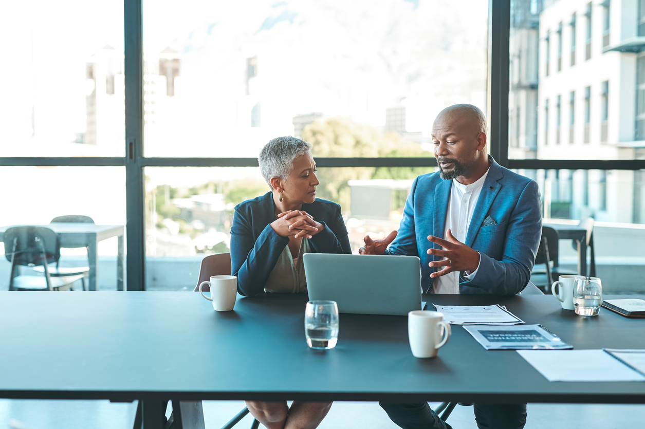 Employees having a conversation in the office.