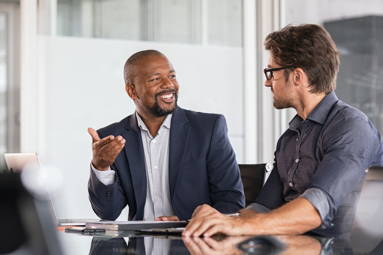 Two happy business colleagues at meeting in modern office interior.