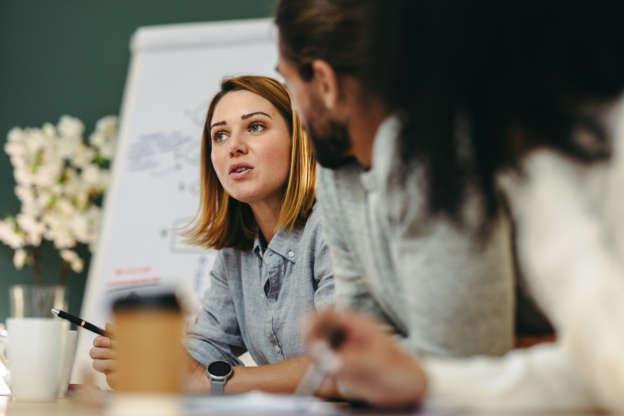 Young business woman having a discussion with employees.