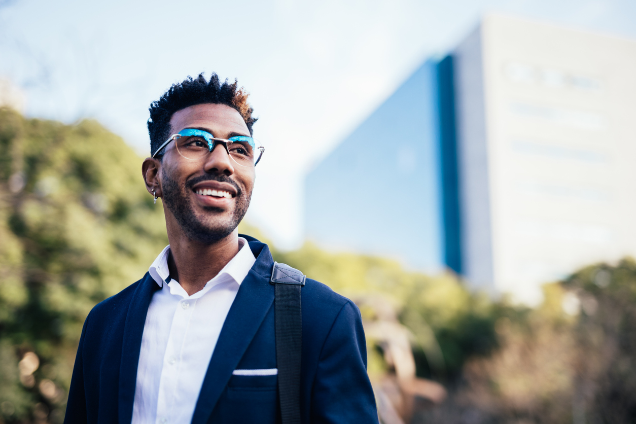 Portrait of dreamy young black man happy about reaching his goals.