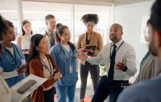 If You Want to Be a Leader, You’ve Gotta Embrace the Suck. Leader talking to employees.