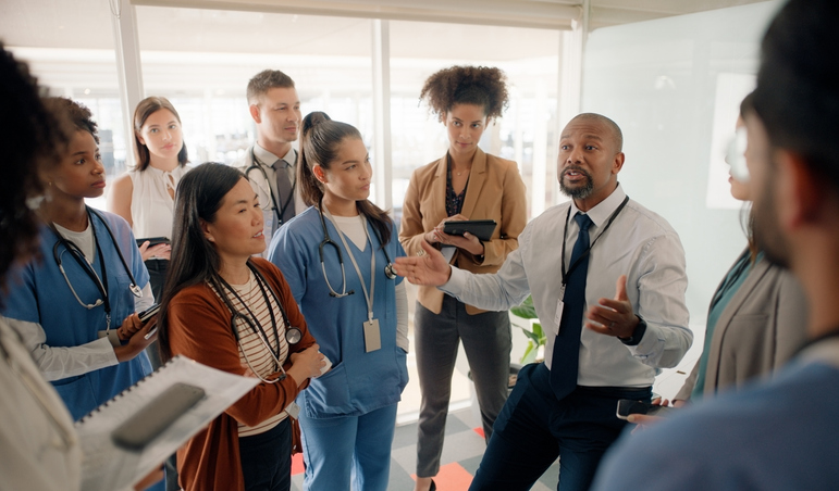 If You Want to Be a Leader, You’ve Gotta Embrace the Suck. Leader talking to employees.